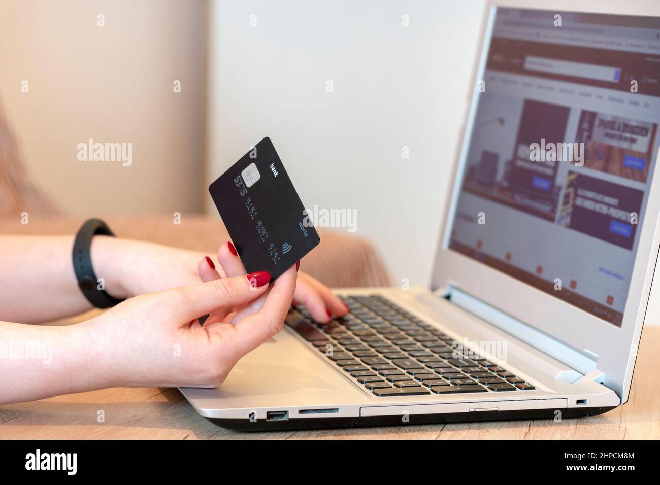 Hand with a card, smartphone on a laptop background. buyer, Shopper.concept online shopping, sales.Concept buyers. Shoppers, shopping concept Stock Photo