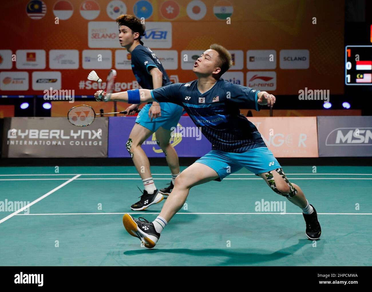 Aaron Chia (R) and Soh Wooi Yik of Malaysia play against Carnando Leo Rolly and Marthin Daniel of Indonesia during the final of the team mens doubles match at the Badminton Asia