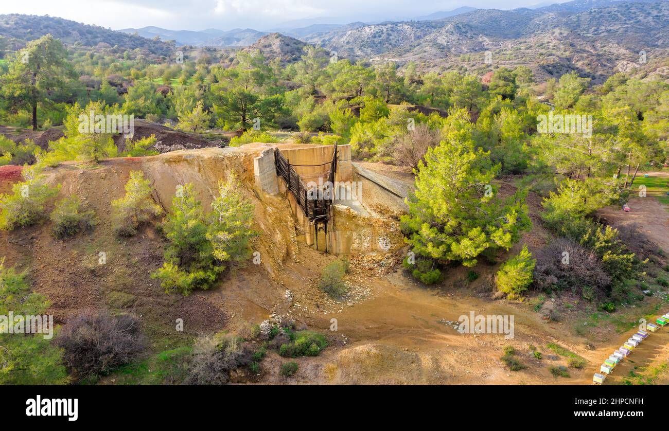 Historical copper mining area since antiquity in Kalavasos, Cyprus. Ore bin and mine tailings from 1950s, and hills of Roman slug behind them Stock Photo