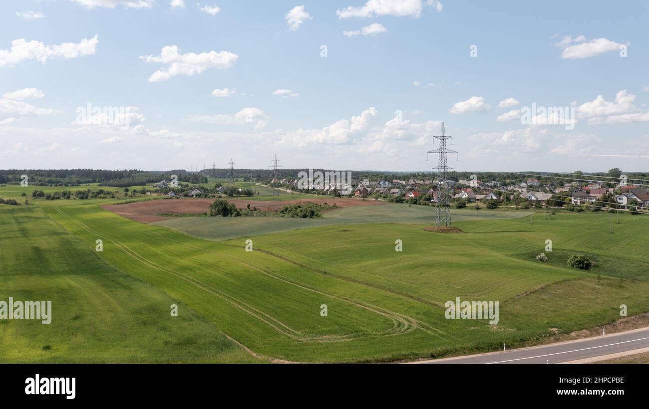 Aerial View of High Voltage Electricity Tower on Green Field. High quality photo Stock Photo