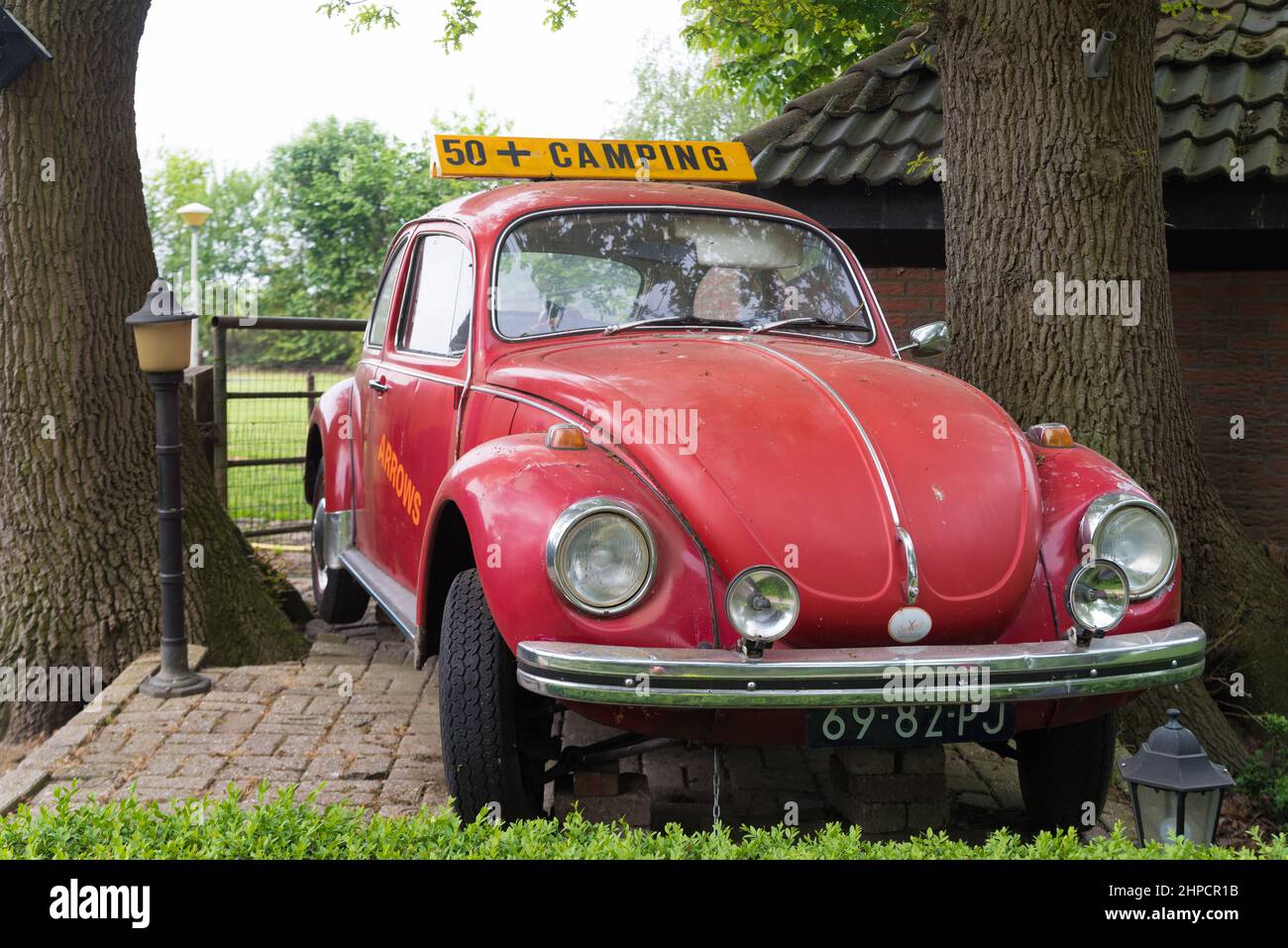 HAARLE, NETHERLANDS - MAY 10, 2020: Red oldtimer VW beetle car as a signboard for a 50+ camping Stock Photo