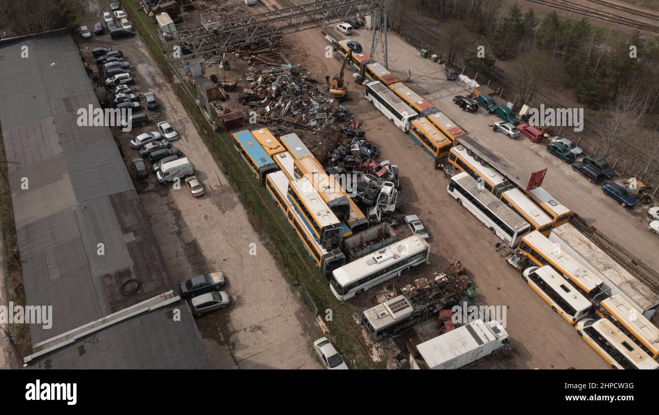 Old Car Metal Scrap Yard with excavator Sorting out old parts Stock Photo