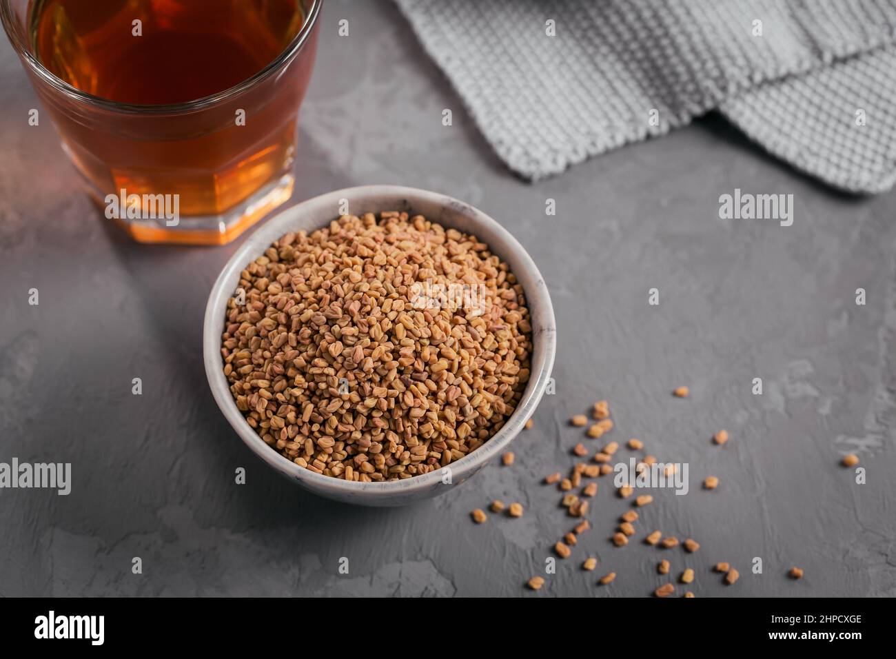 Bowl of fenugreek seeds and Egyptian fenugreek yellow tea or Methi Dana