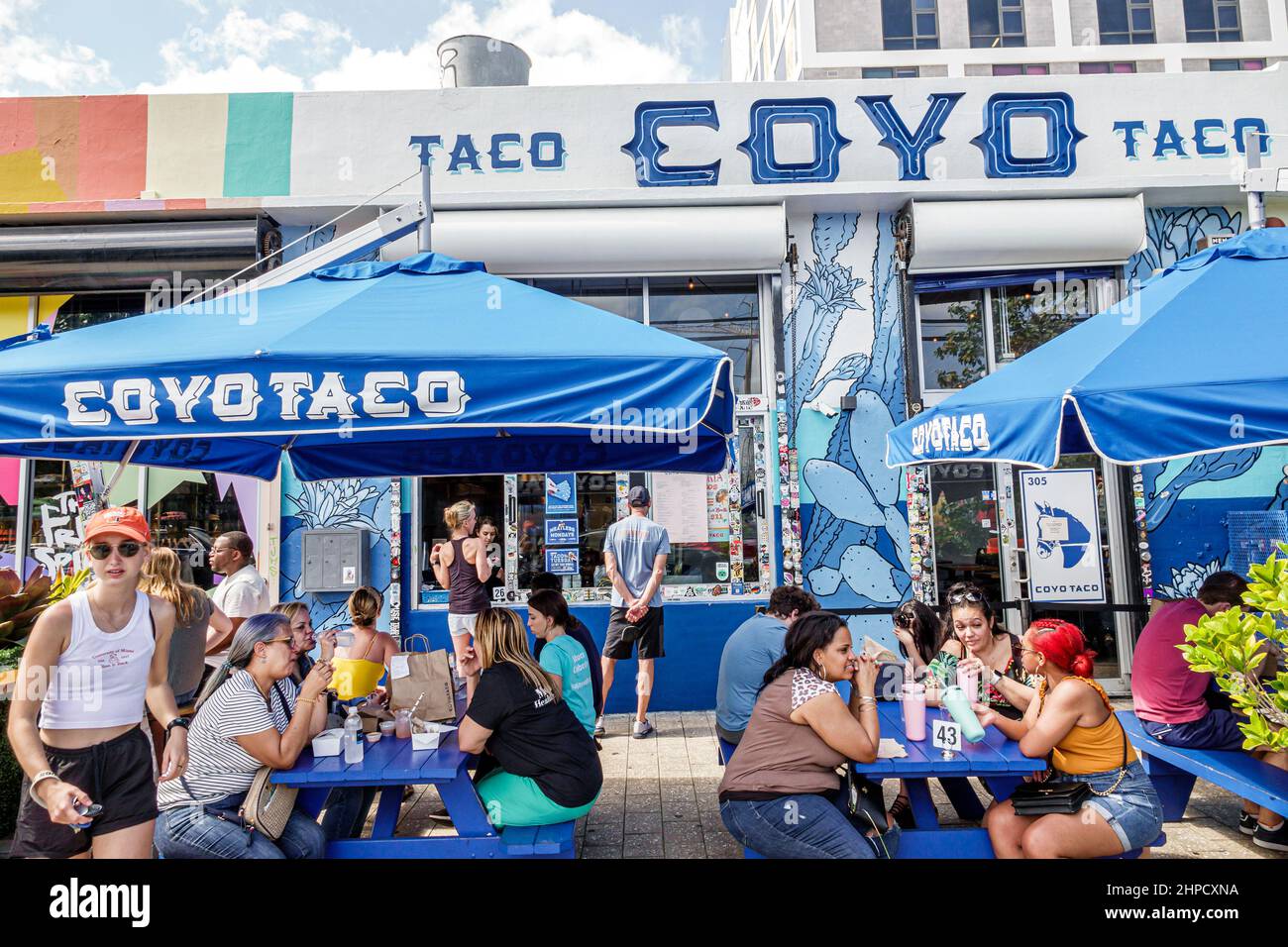 Miami Florida Wynwood Art District Coyo Taco Mexican street food restaurant tables umbrellas al fresco outside exterior Stock Photo