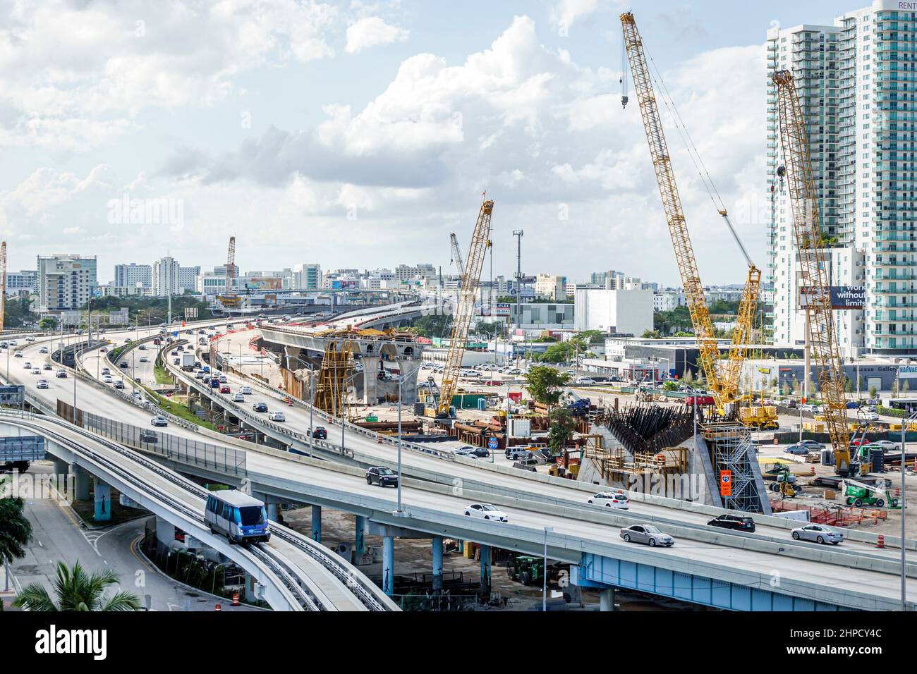 Miami Florida I-395 highway Dolphin Expressway MacArthur Causeway road construction site cranes Metromover rail shuttle people mover free public trans Stock Photo