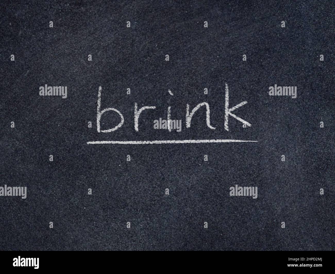 brink concept word on blackboard background Stock Photo