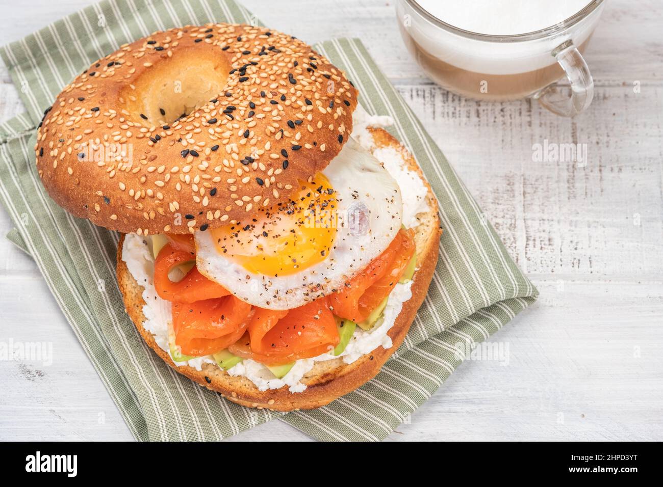 Bagel sandwich with smoked salmon, cream cheese, avocado and egg Stock