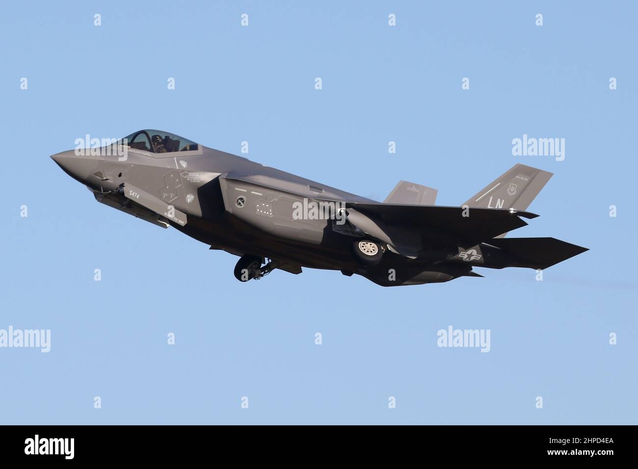 USAFE F-35A Lightning II from the newly reformed 495th Fighter Squadron overshooting it's home base of RAF Lakenheath on a bright morning. Stock Photo