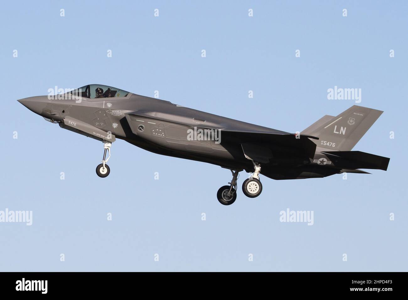 USAFE F-35A Lightning II from the newly reformed 495th Fighter Squadron landing at it's home base of RAF Lakenheath on a bright morning. Stock Photo