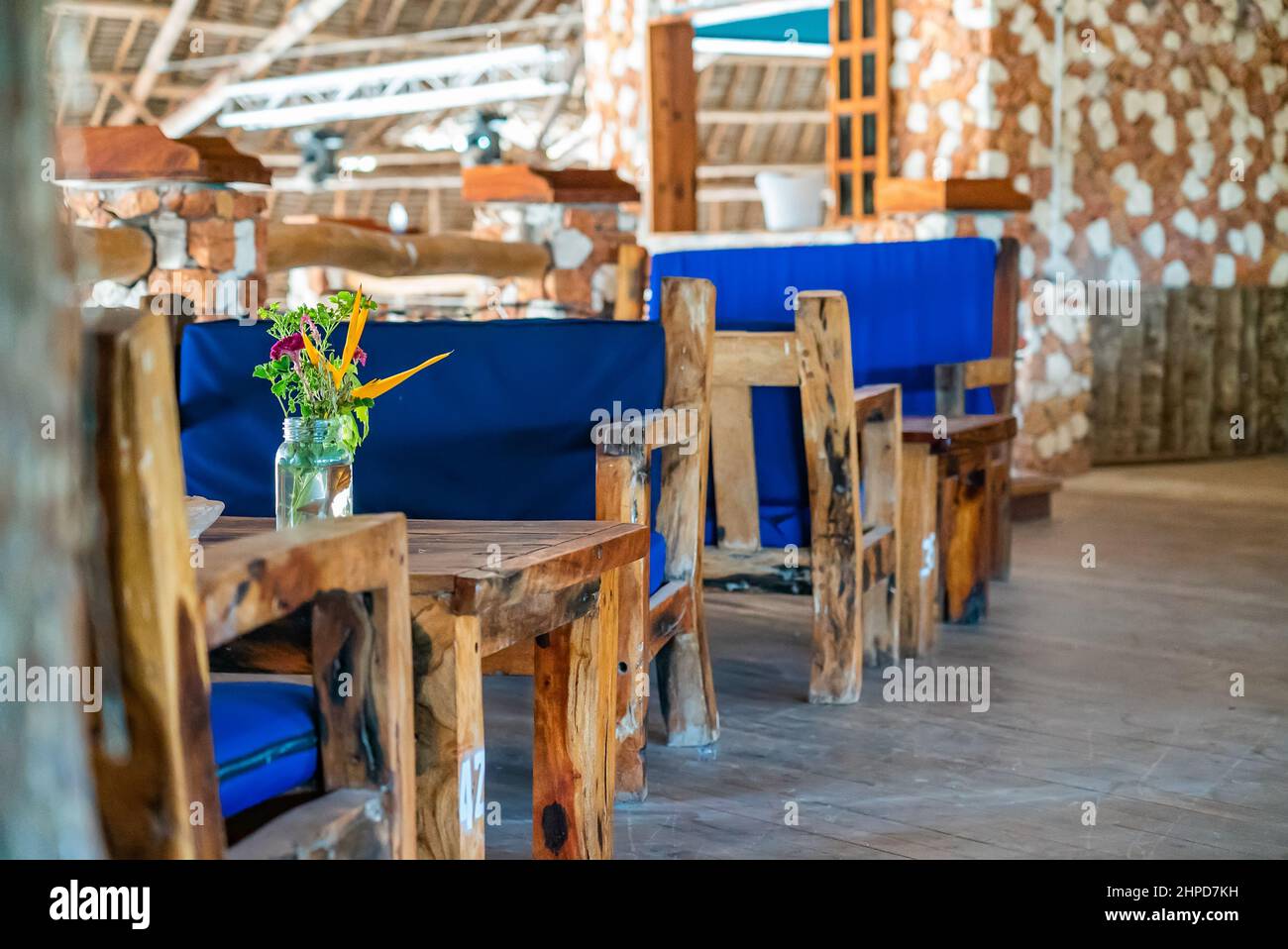 Wooden tables in cafe. Authentic interior of restaurant in Kendwa, Zanzibar, Tanzania. Stock Photo