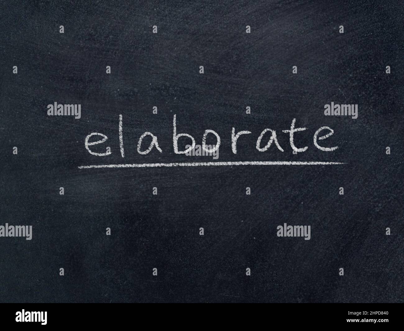 elaborate concept word on blackboard background Stock Photo - Alamy
