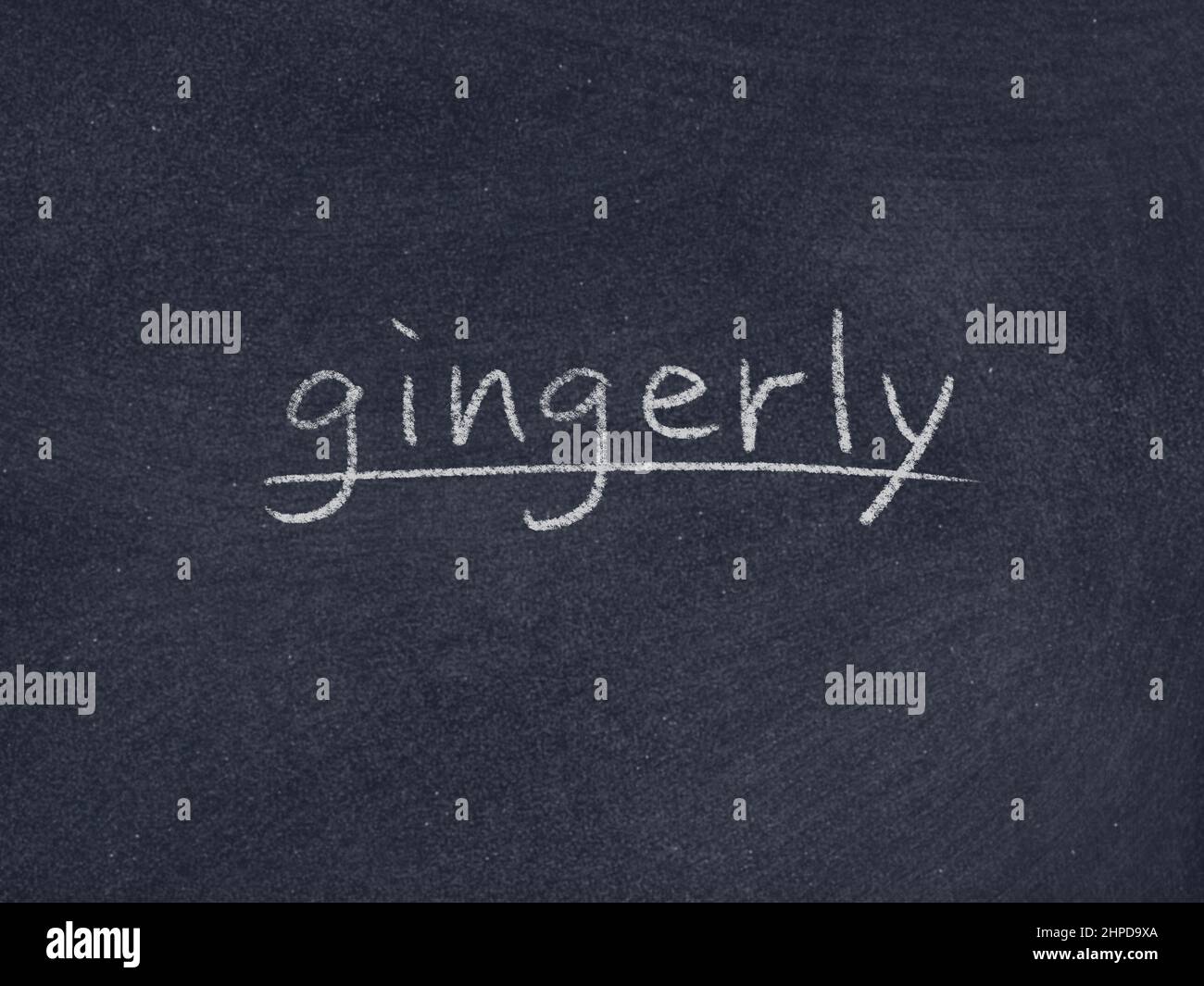 gingerly concept word on blackboard background Stock Photo