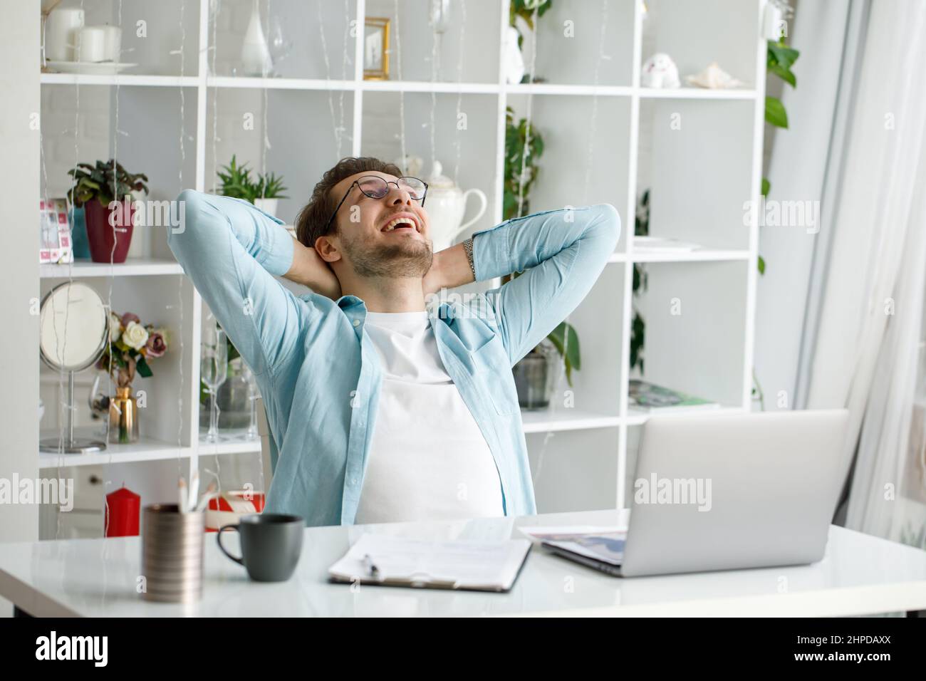 An attractive young man is working on a laptop. Stock Photo