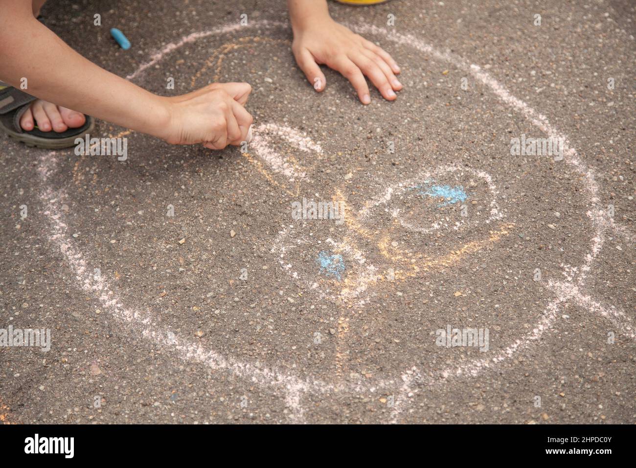 Children drawing on a pavement with chalk hi-res stock photography and ...