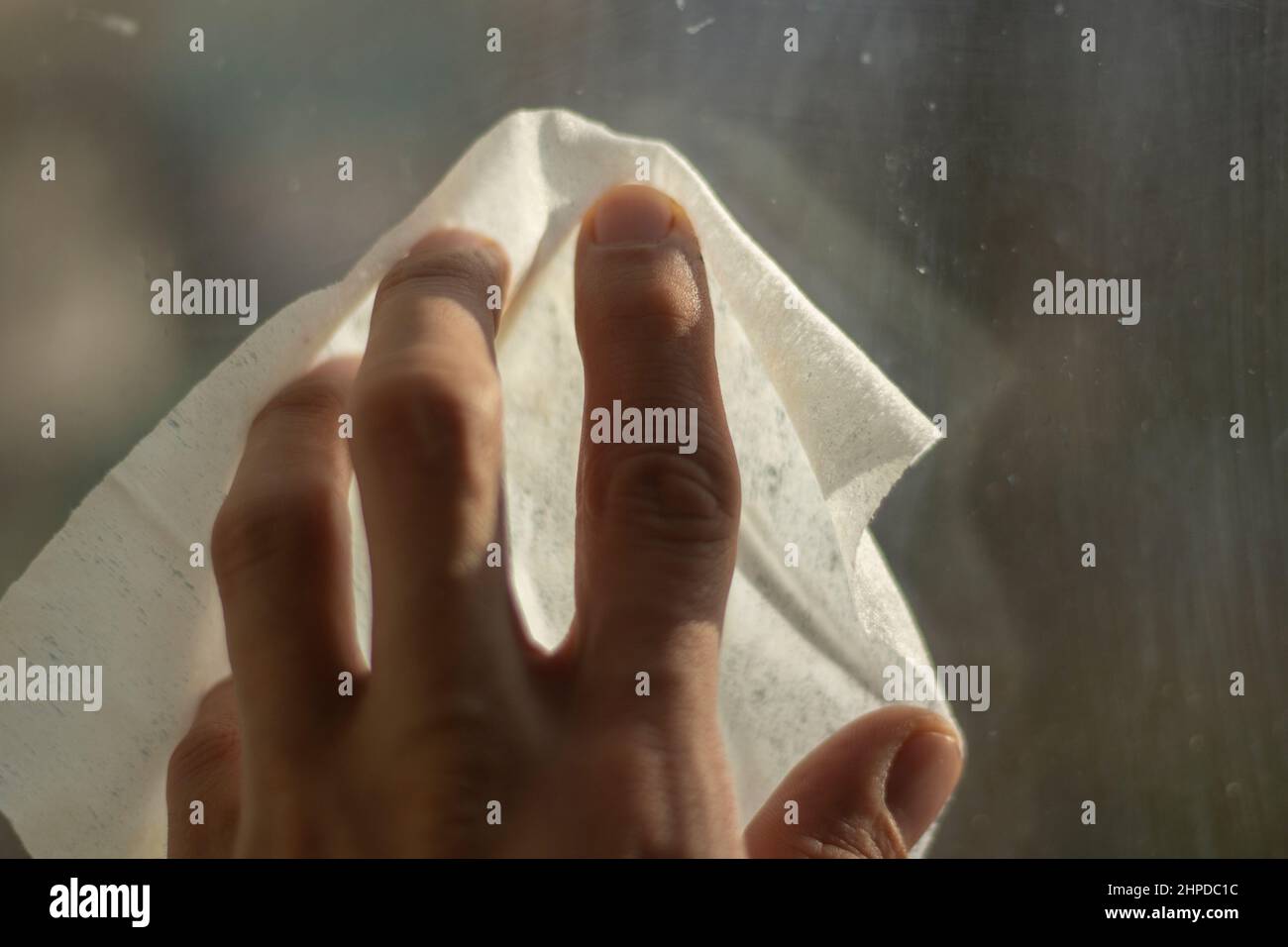 Wiping window from dirt. Cleaning of room. Erasing dust with damp cloth