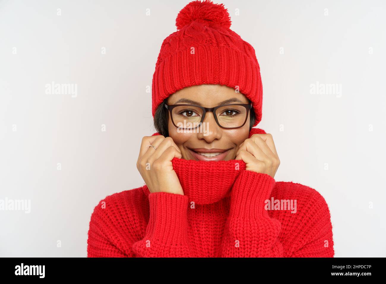 Funny woman wearing warm knitted hat and sweater. African american woman dressed winter in clothes Stock Photo