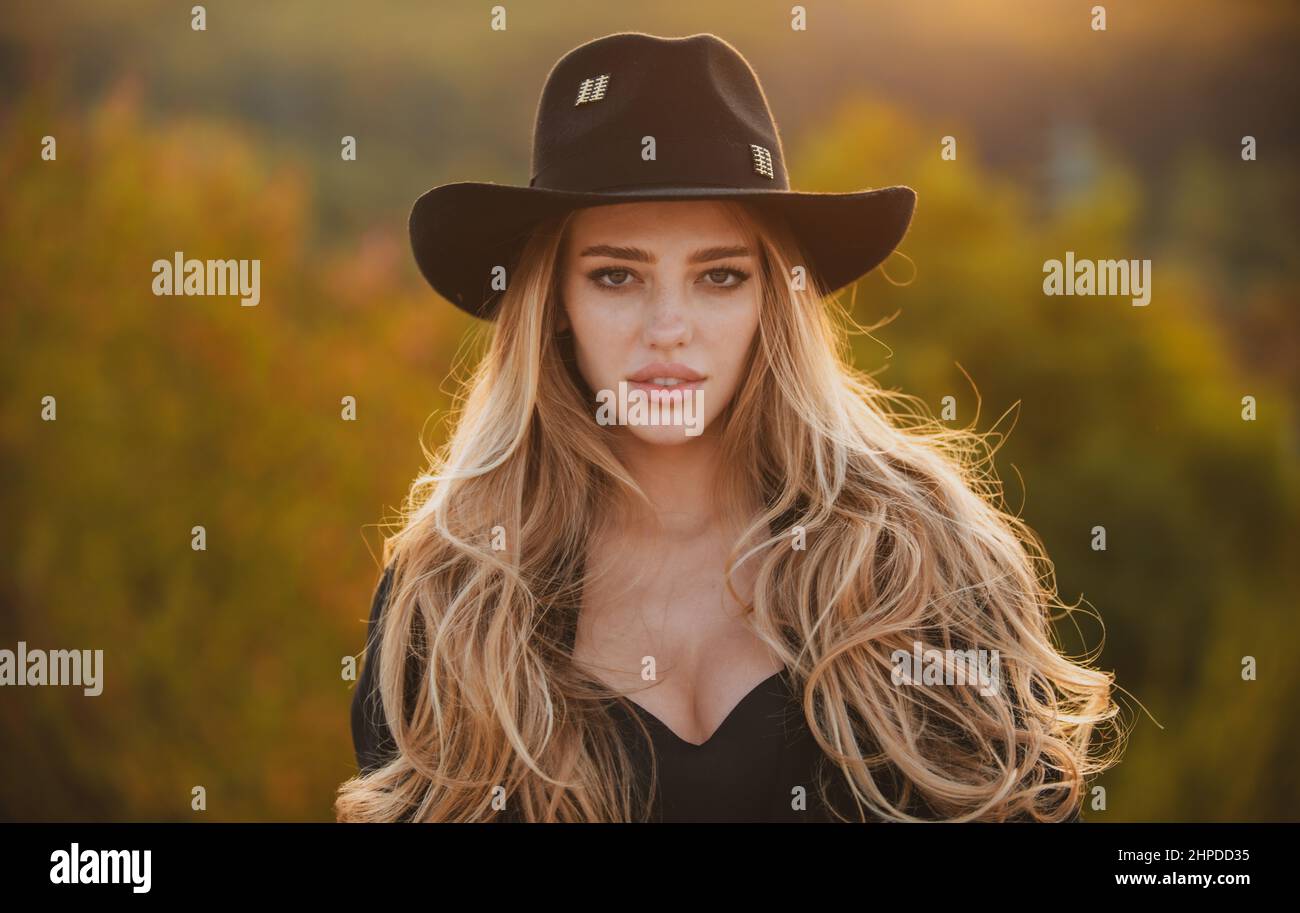 Portrait of beautiful young woman in summer vogue hat. Outdoor portrait ...