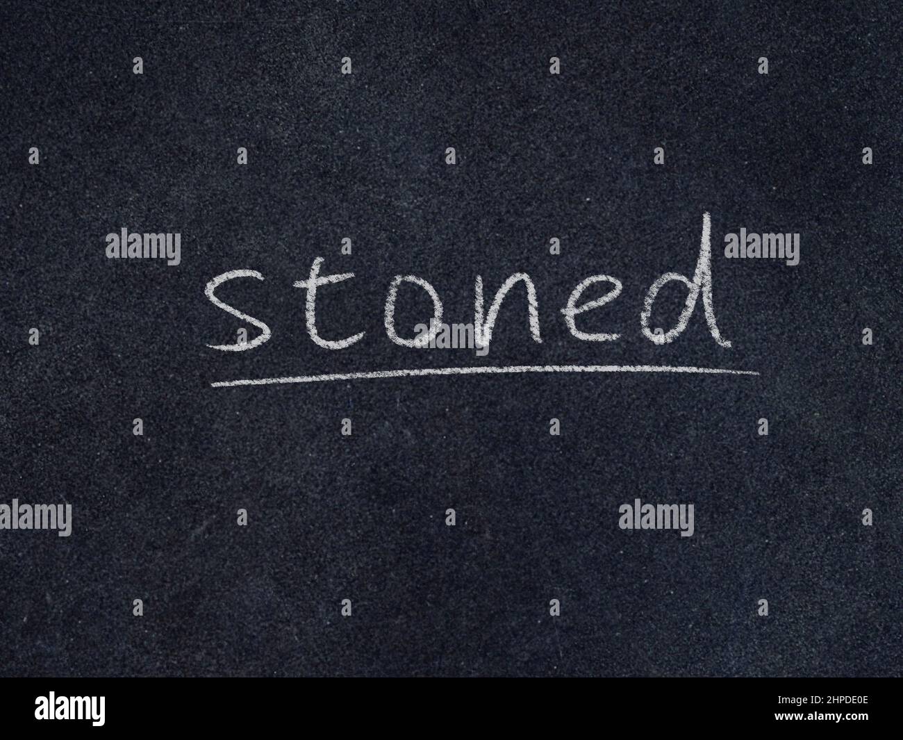 stoned concept word on blackboard background Stock Photo
