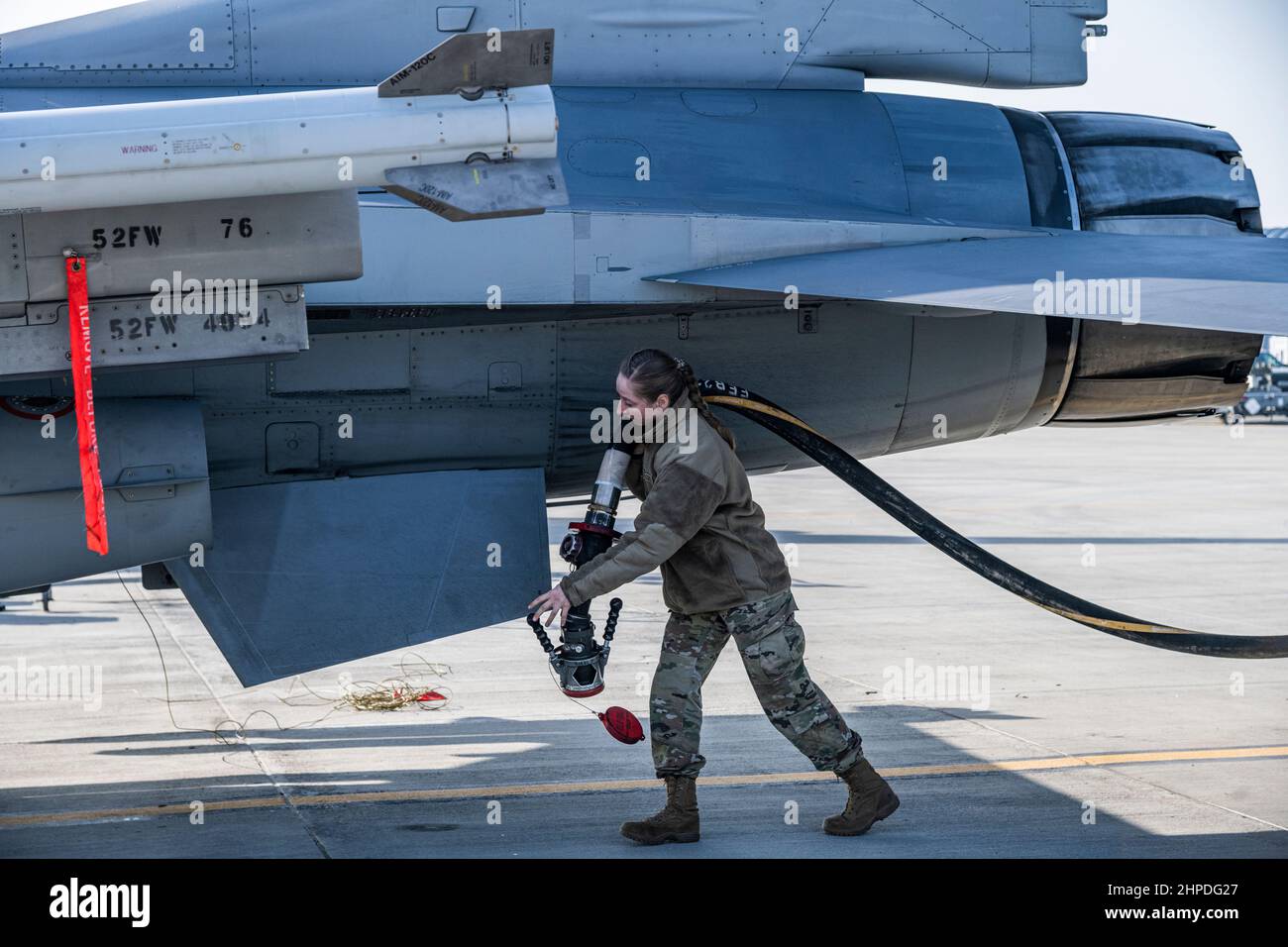 A U.S. Air Force Airman from the 480th Expeditionary Fighter Squadron petroleum, oils and lubricants flight at Spangdahlem Air Base, Germany, prepares to refuel an F-16 Fighting Falcon aircraft assigned to the 480th FS at the 86th Air Base, Romania, Feb. 17, 2022. U.S. forces in Europe live, train and operate with allies and partners from strategic locations across Europe that are critical for the timely and coordinated response during peacetime and crises. (U.S. Air Force photo by Senior Airman Ali Stewart) Stock Photo