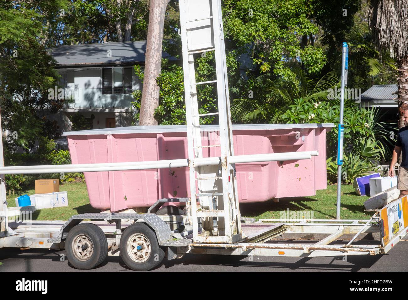 Fibreglass swimming pool being delivered to a home in Sydney being held