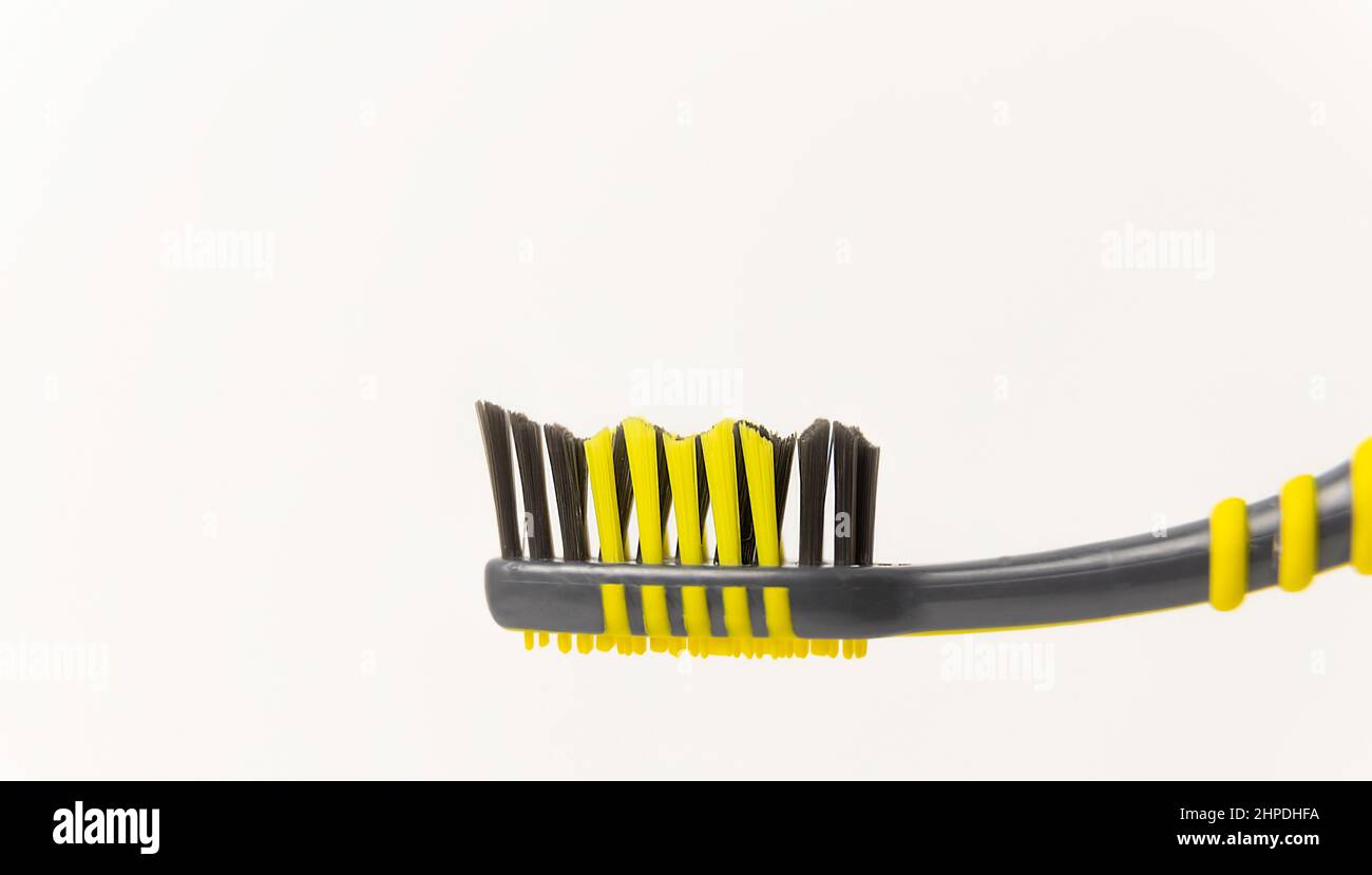 Oral hygiene. Black and yellow toothbrush on a white background Stock ...