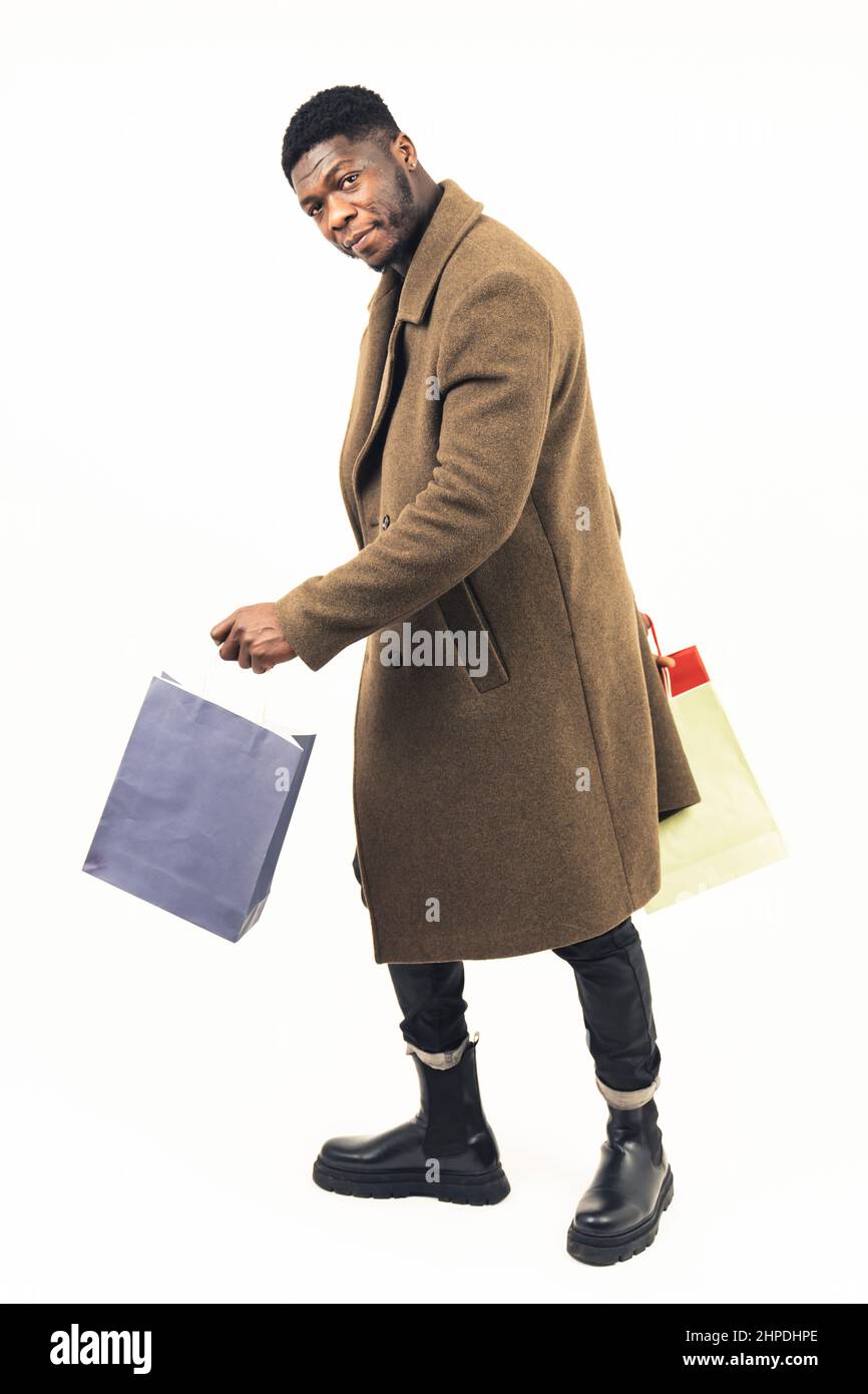 Afroamerican man doing shopping white background - full shot. High-quality photo Stock Photo