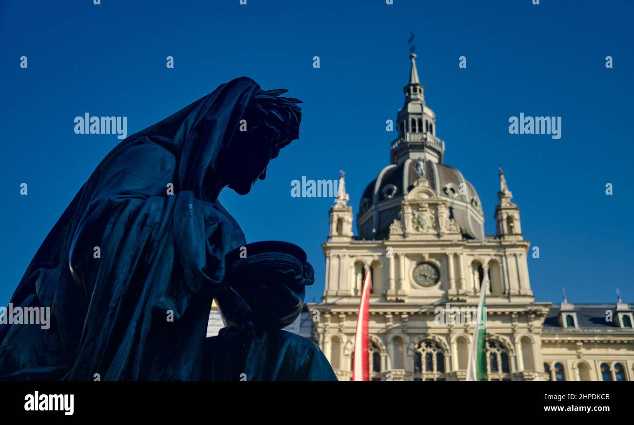 City Hall in Graz with statue in front on the main square during the day with blue sky Stock Photo