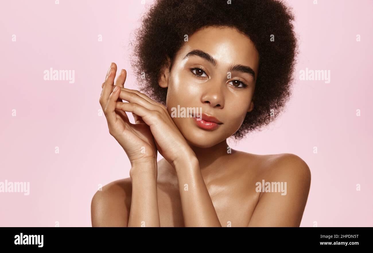 Skin care. African american woman with beauty face touching healthy ...