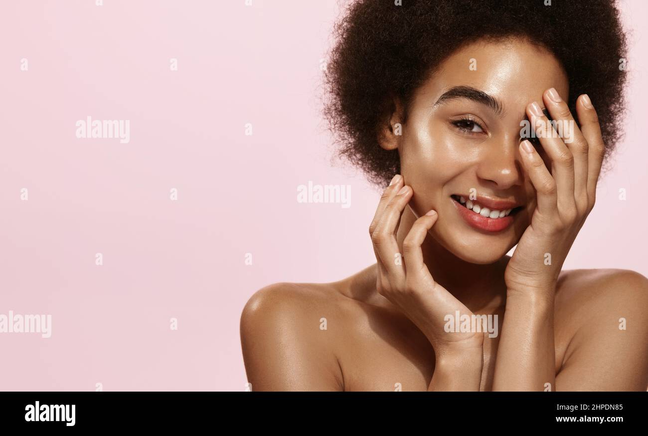 Skin care. African american woman with beauty face touching healthy