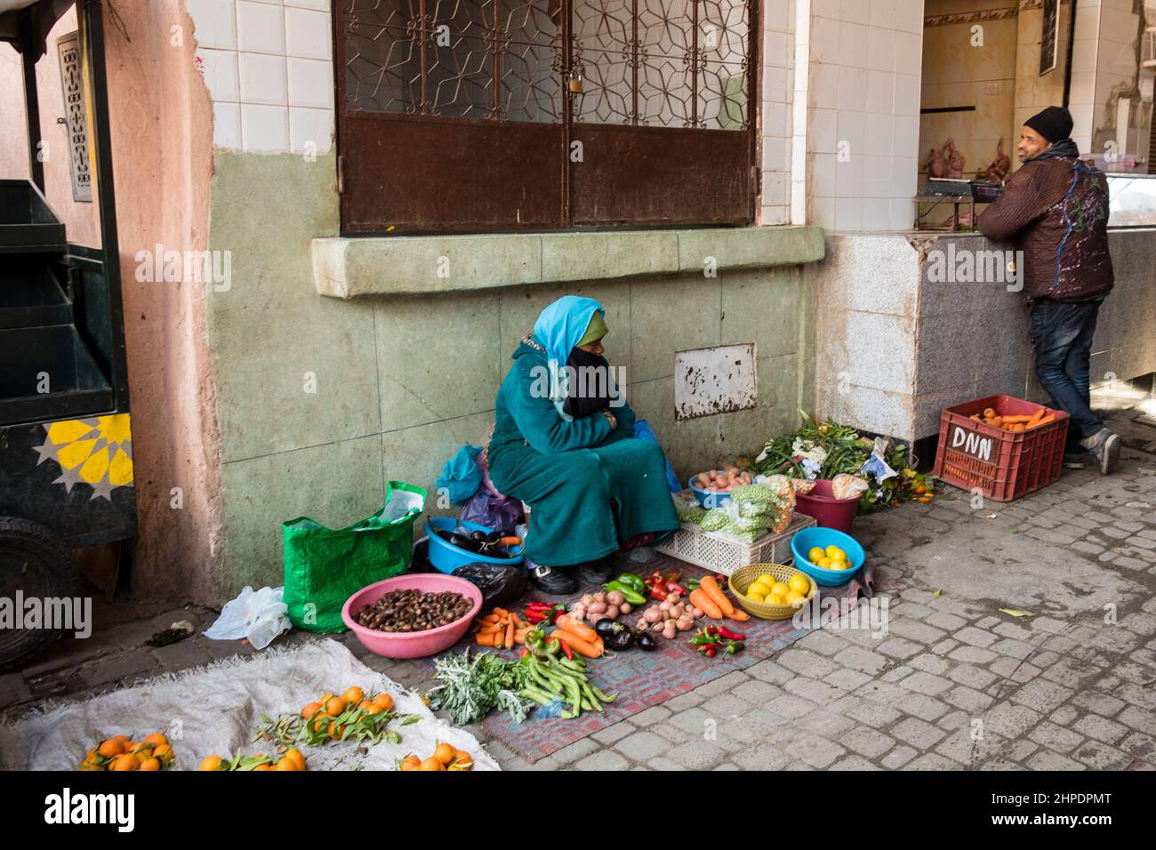 Moroccan woman sells fresh produce in the Medina, Marrakech, Morocco Stock Photo