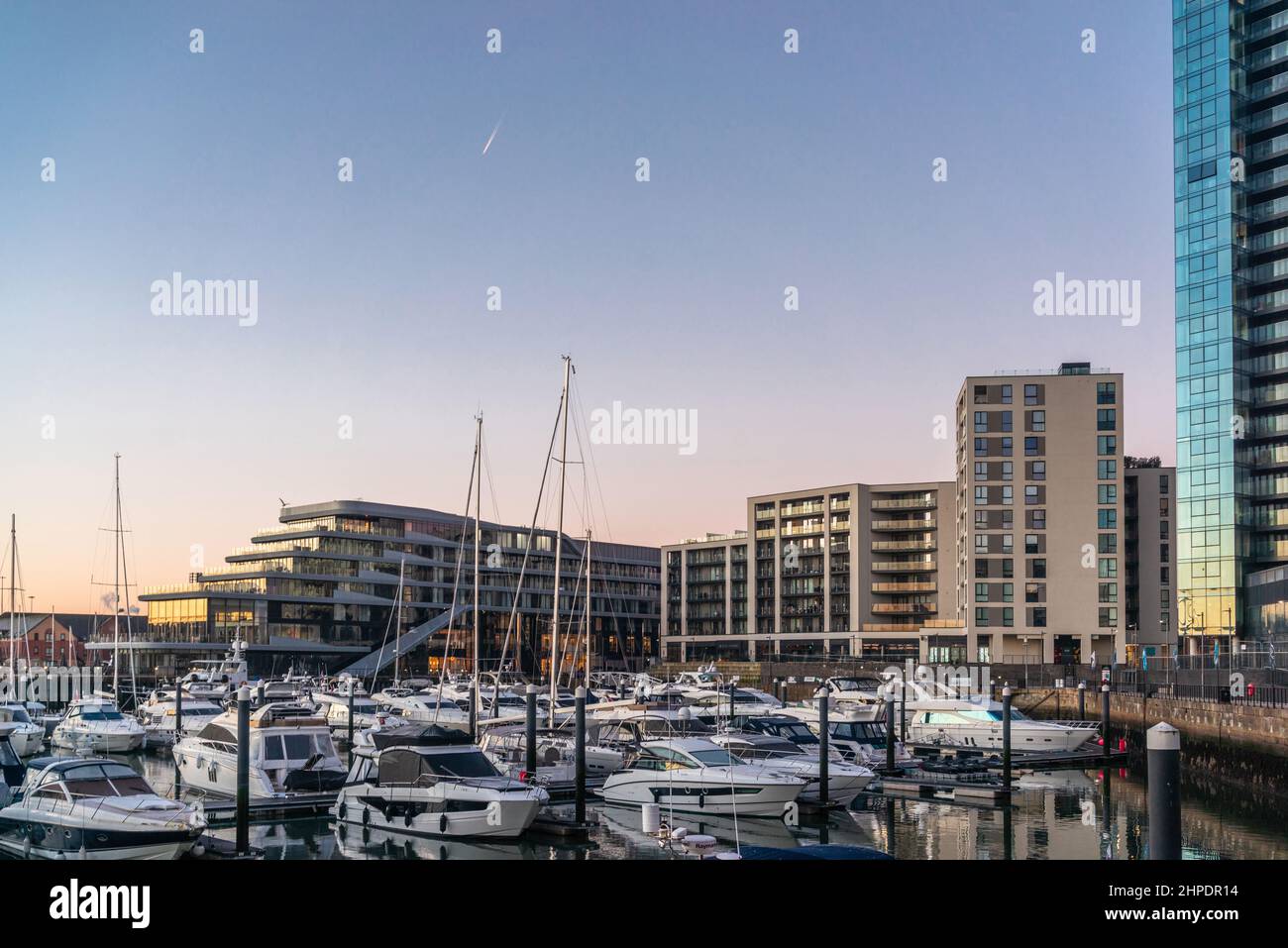 Boats moored at Ocean Village Marina at sunrise with view to the Harbour hotel, Southampton, Hampshire, England, UK Stock Photo