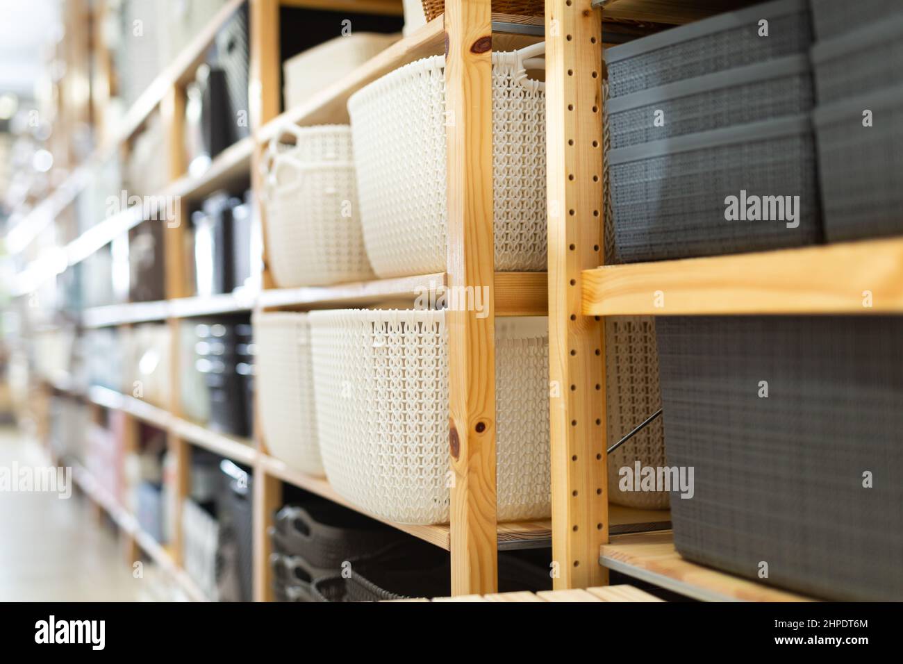 Decorative plastic storage boxes on shelves of store Stock Photo Alamy
