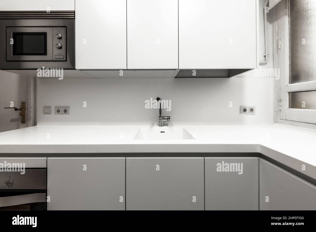 Kitchen with white onepiece countertop and stainless steel appliances