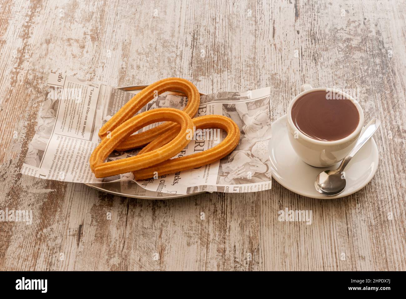 Typical Spanish breakfast or snack of hot chocolate with fried churros Stock Photo