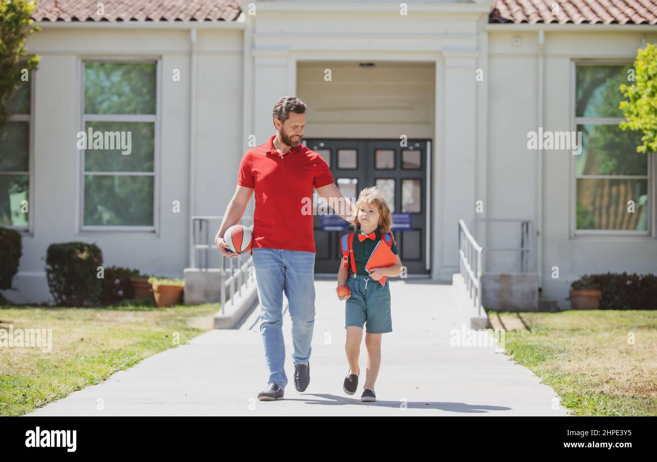 Father walking son to school. Parent and pupil of primary school