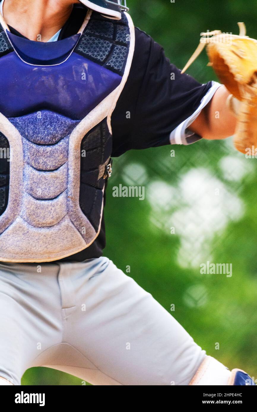 The mid body of a catcher throwing the ball back to the pitcher. Stock Photo