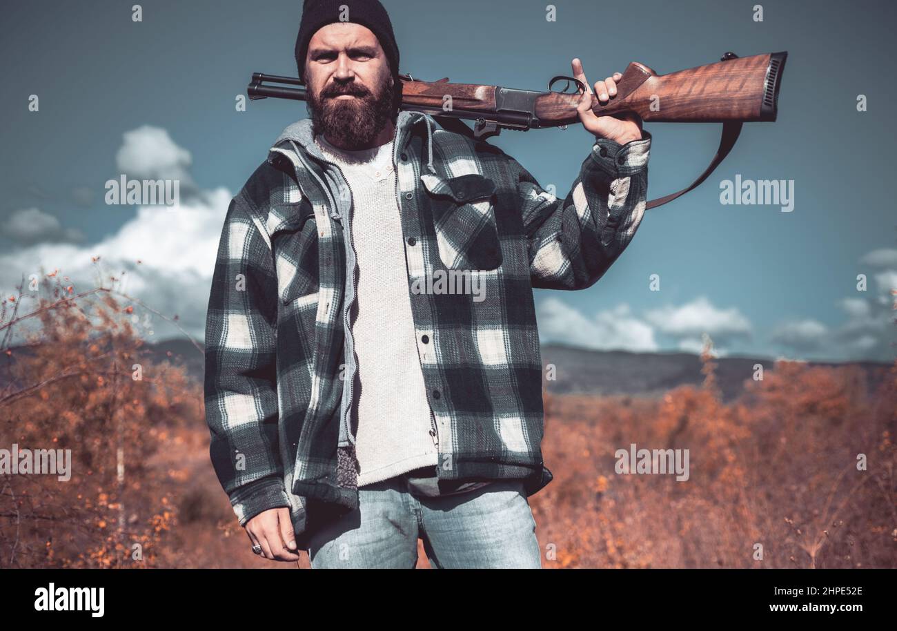 Clothes for the hunter. Hunter with shotgun gun on hunt. Man holding shotgun. Small game. Hunting gun. Stock Photo