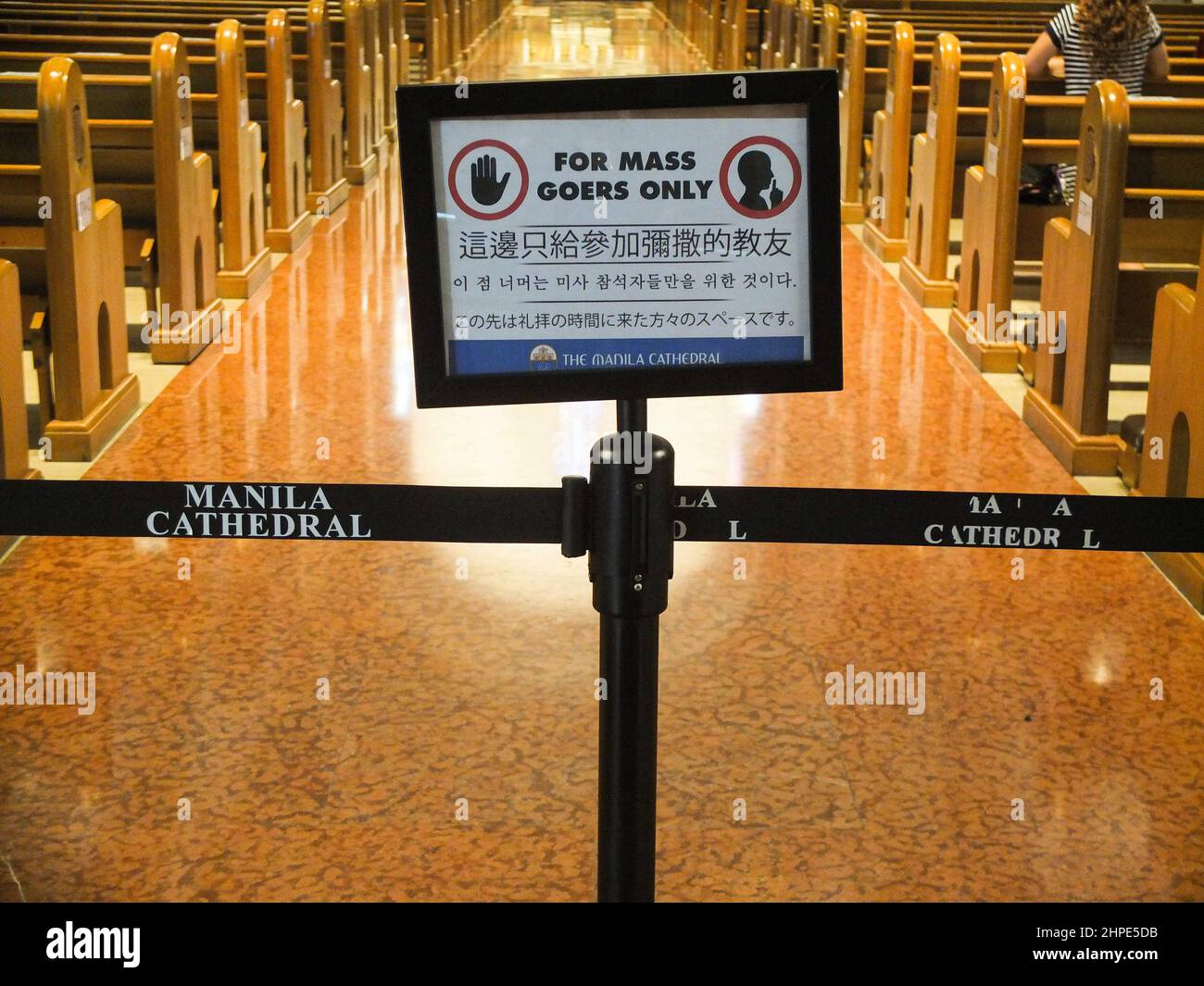 A warning sign for mass goers seen inside the cathedral in Manila ...