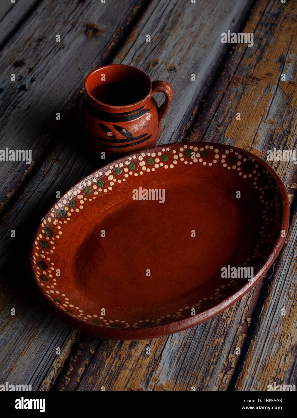 Mexican plates made of mud or clay on a rustic wooden table Stock Photo -  Alamy