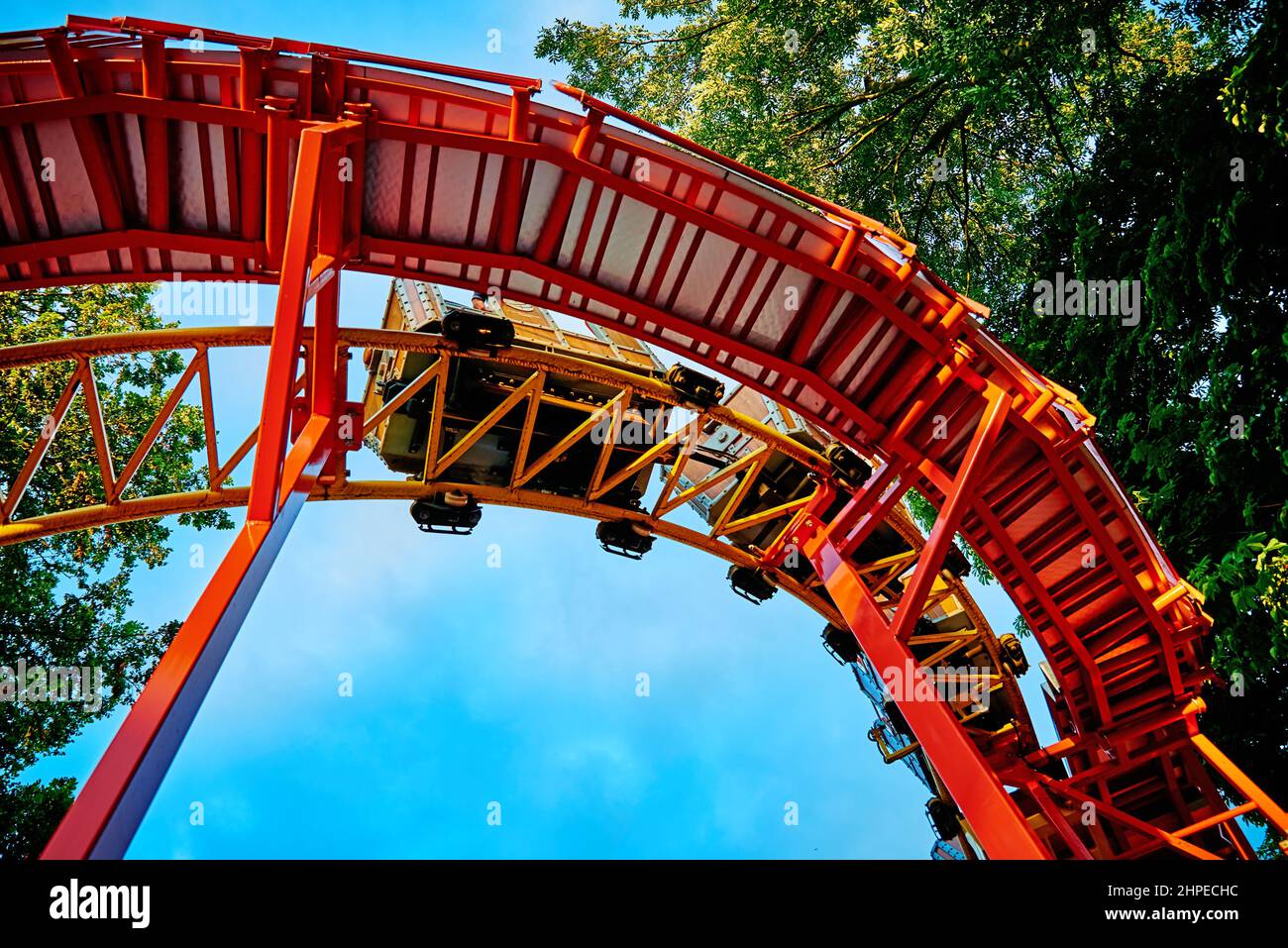 Part of looping roller coaster at summer day, Riding a rollercoaster at amusement park Stock Photo