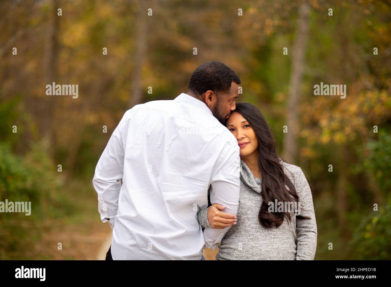 Portrait of a mixed race couple who are expecting parents Stock Photo