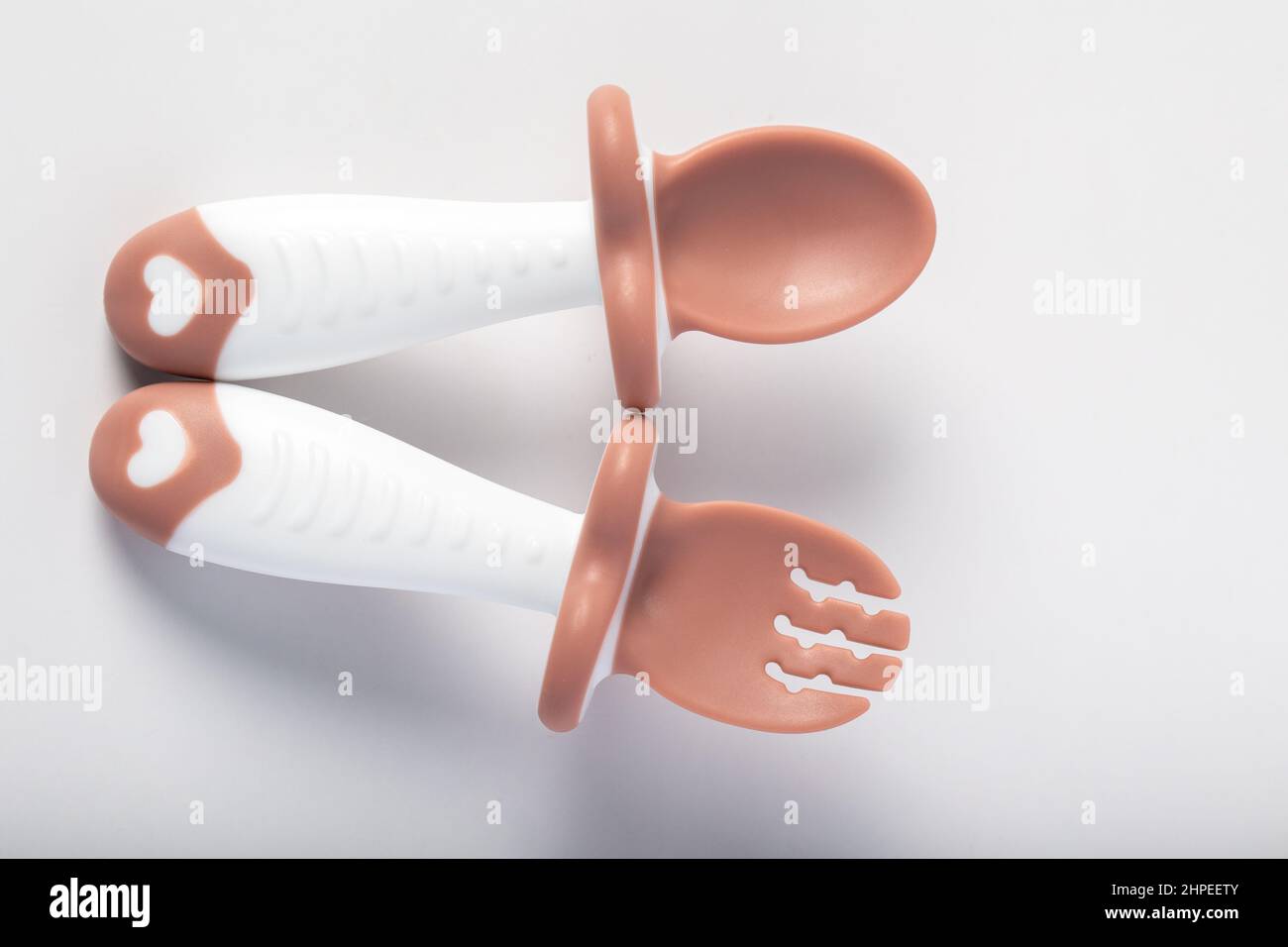 spoon and fork for baby used isolated on white Stock Photo - Alamy