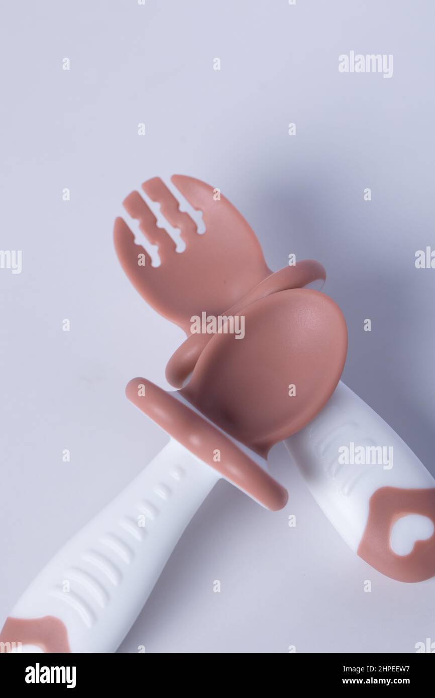 spoon and fork for baby used isolated on white Stock Photo - Alamy