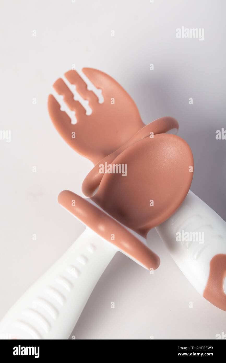spoon and fork for baby used isolated on white Stock Photo - Alamy