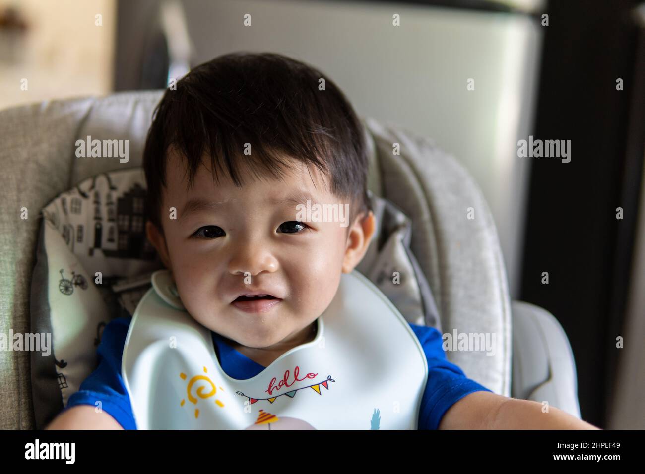 Adorable joyful and Happy 1 years old Chinese baby boy having food