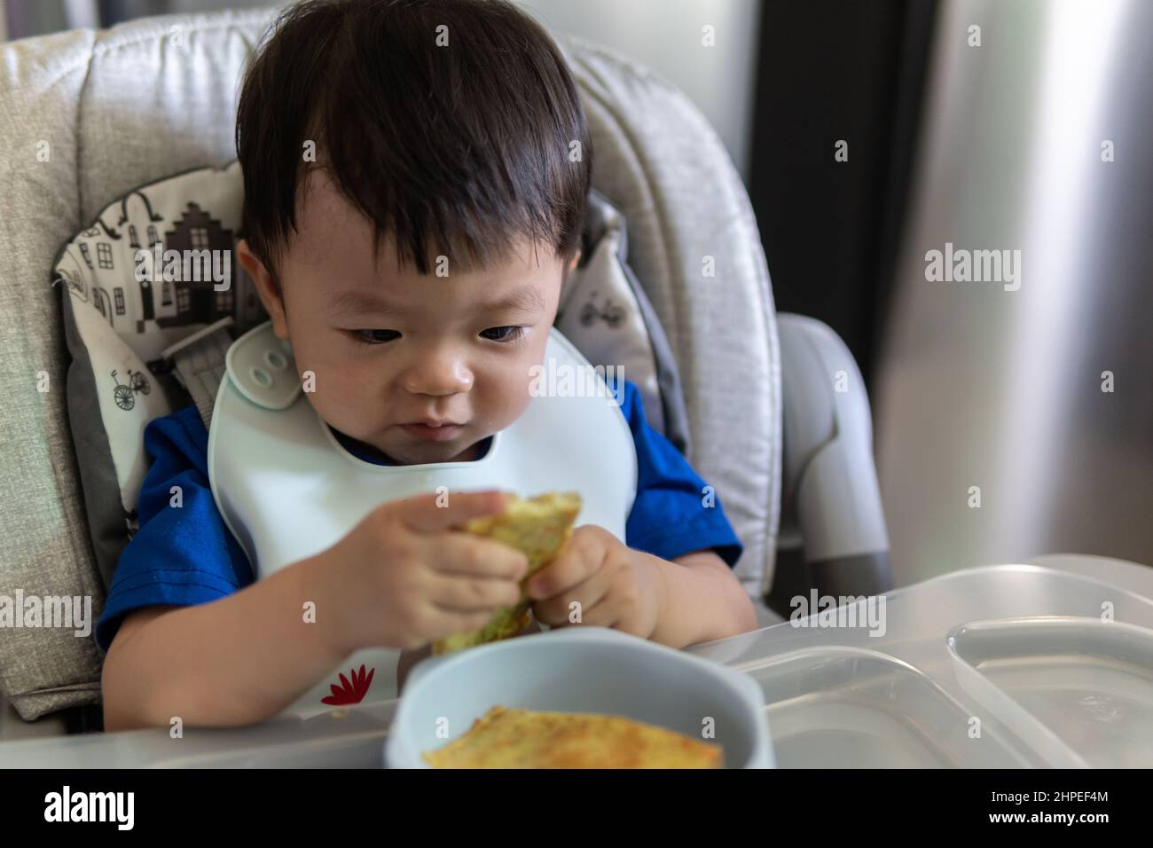 Adorable Joyful And Happy 1 Years Old Chinese Baby Boy Having Food