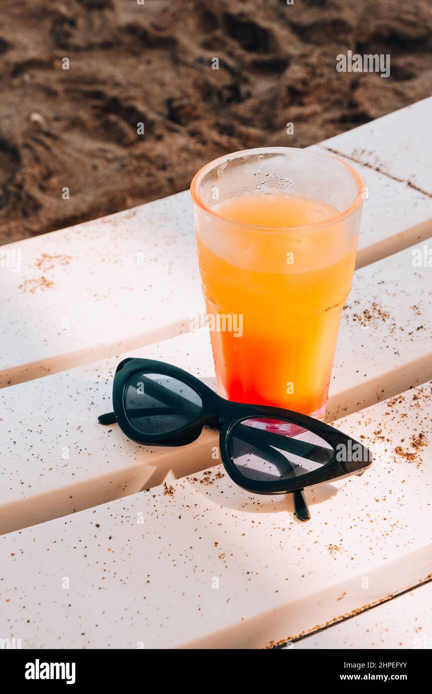 Fresh cold mango smoothie cocktail on tropical beach bright sand ...