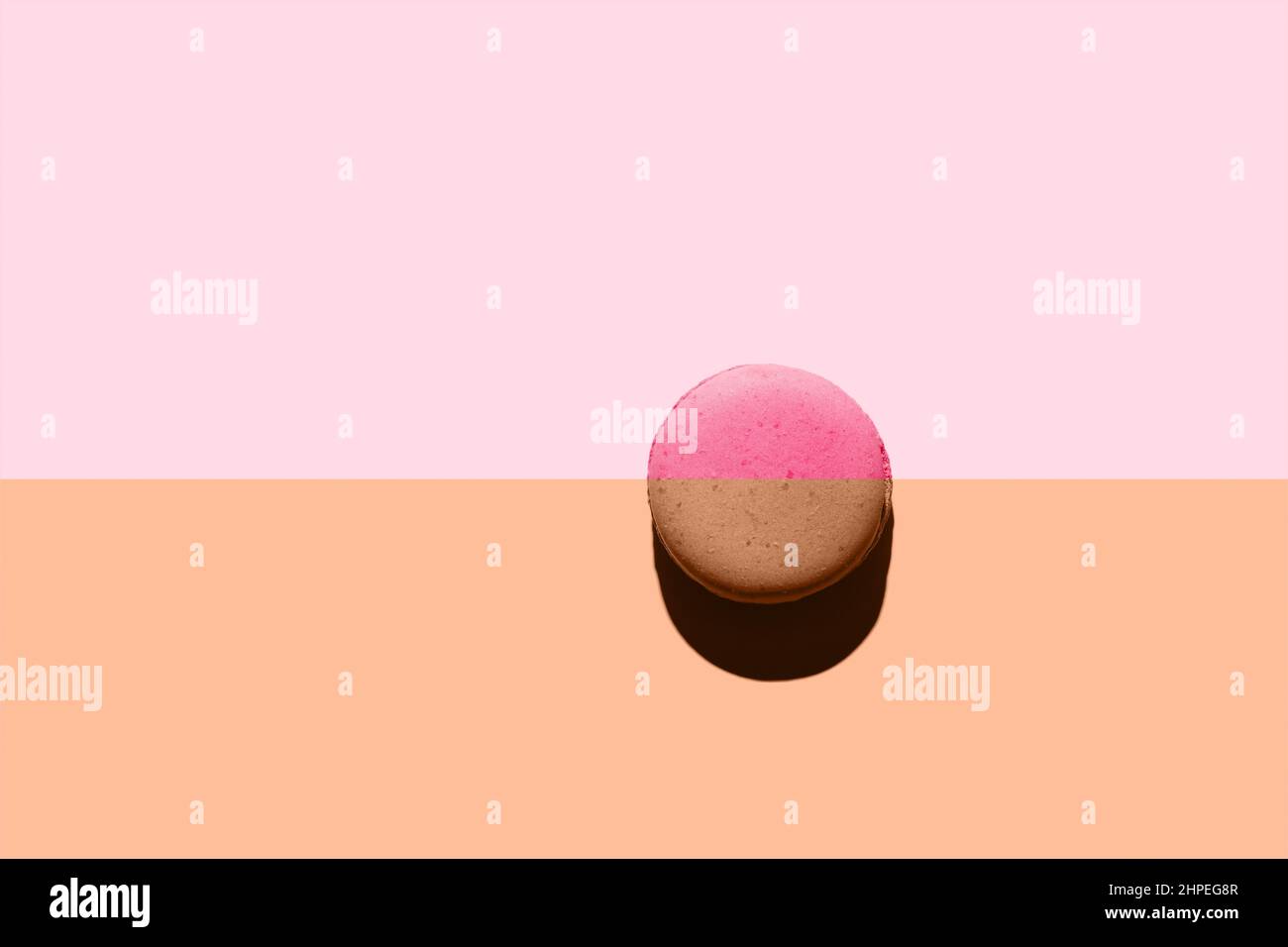 Macaroon with creative layout. Two colors duotone macaron with top view with hard light. Stock Photo