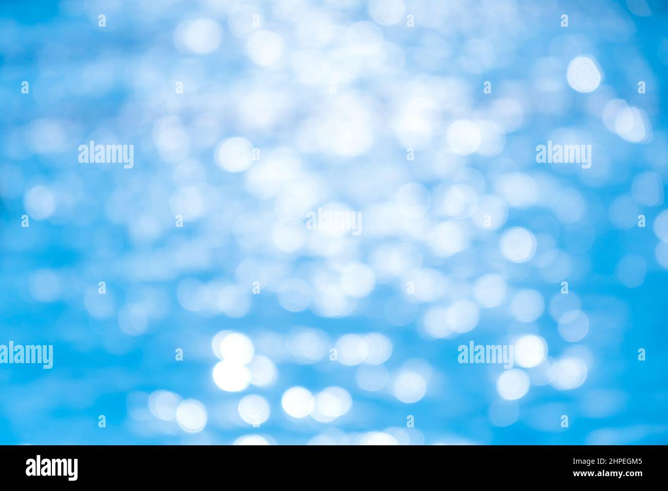 Defocused blured Pure blue water in the swimming pool with light ...