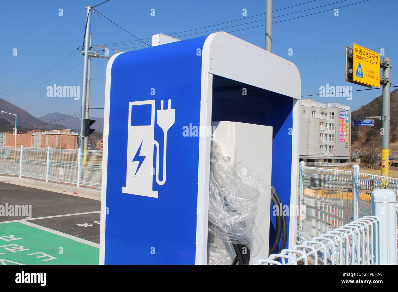 Electric vehicle charging station in parking lot Stock Photo Alamy